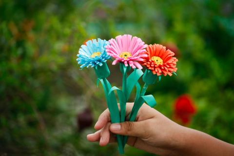 Hand Holding Floral Pens