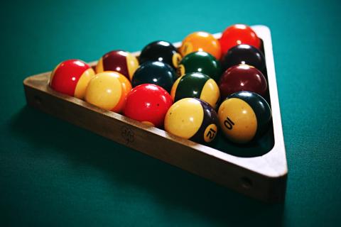 Pool table with billard balls racked.