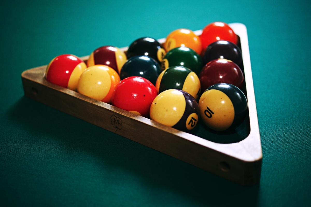 Pool table with billard balls racked.