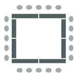 Table arranged in a square formation with chairs around the outside. 